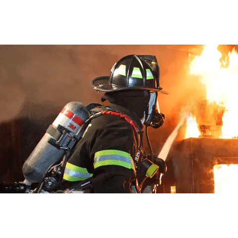 Firefighter wearing the Fire-Dex® H41 Interceptor with STEDAIR® Prevent jacket while hosing down a fire, showing thermal protection, waterproof outer layer, and operational flexibility.