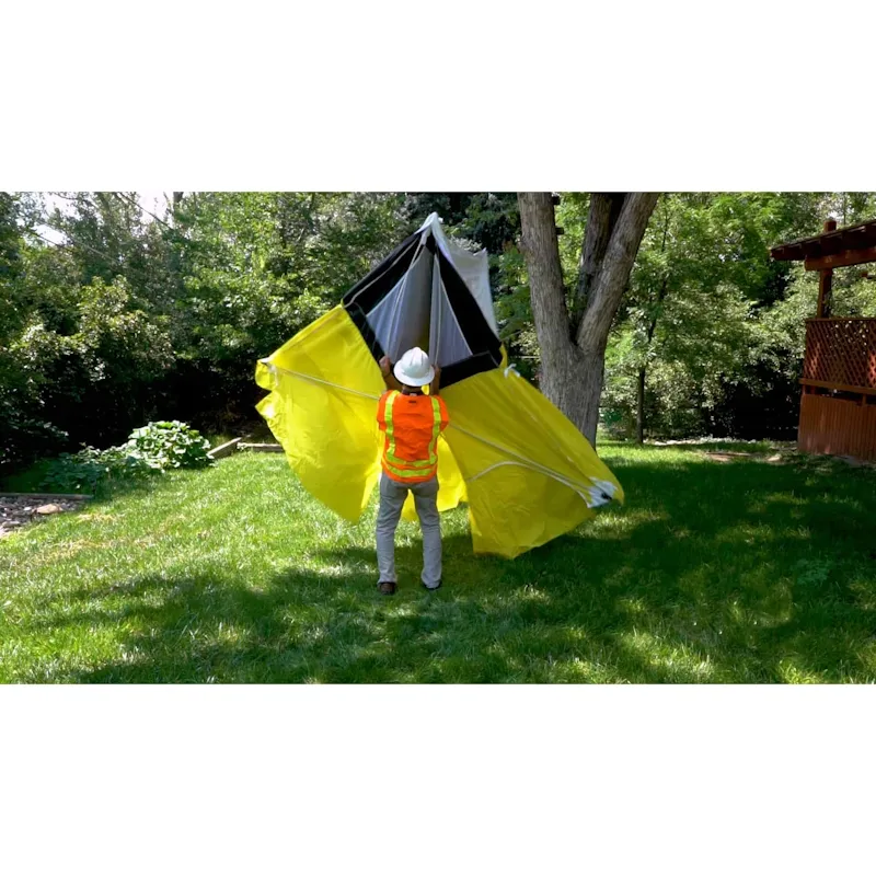 Person outside unfolding a Pelsue® Interlocking Series Work Tent, showcasing lightweight materials and rapid deployment features.
