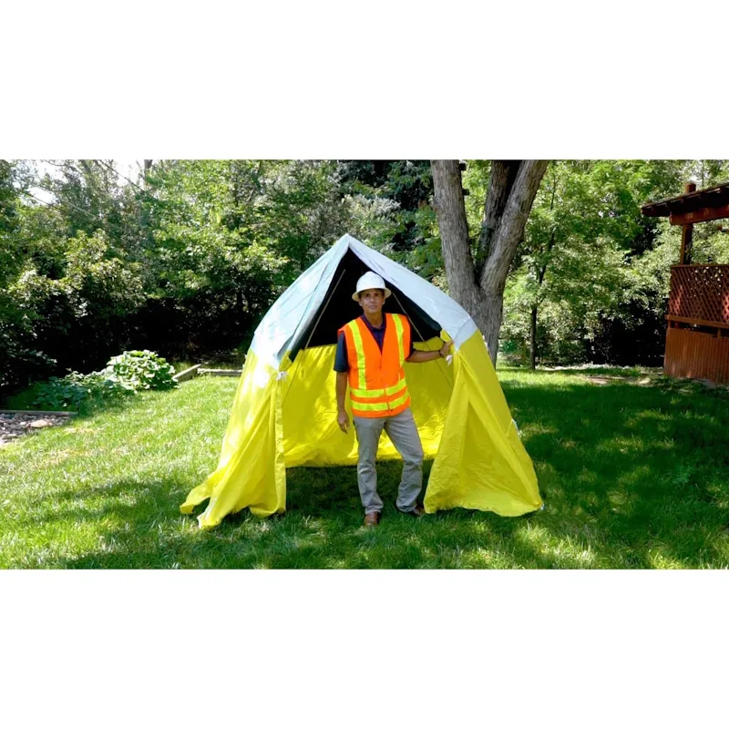 Person standing outside in front of a fully deployed Pelsue® Interlocking Series Work Tent, illustrating spacious, weather-resistant shelter for work or emergency operations.