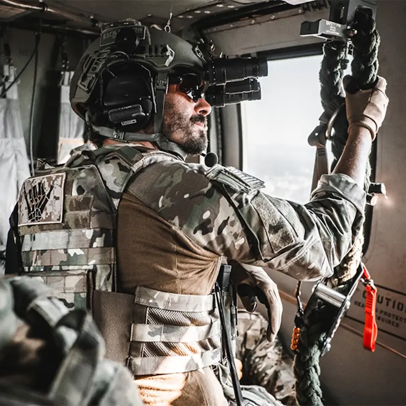 Soldier wearing the Team Wendy® EXFIL® Ballistic SL Helmet inside a vehicle, showcasing its compact fit, comfort, and compatibility with mounted communication systems.