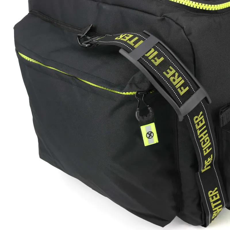 Close-up of the Lightning X LXFB20 black turnout gear bag's side zipper pocket with hi-vis yellow zipper and Fire Fighter shoulder strap with rigid shoulder pad.