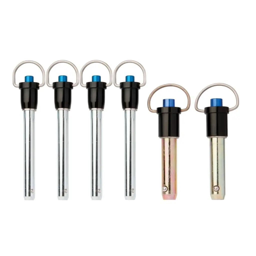 Close-up of six metal quick-release pins with blue locking buttons and circular pull rings, used for securing components in the CMC™ Arizona Vortex Kit tripod system.