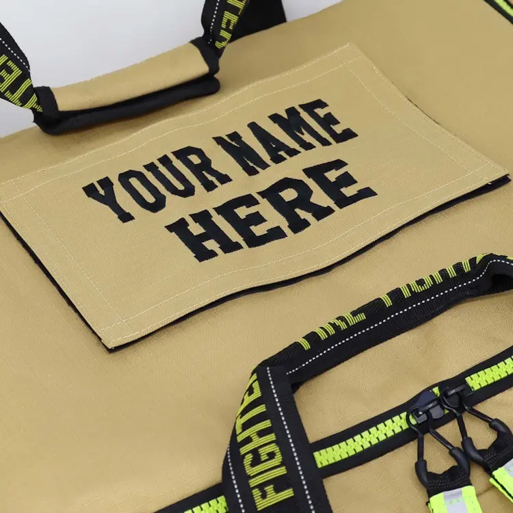 Close-up view of the top of Lightning X LXFB10XT 3XL Ripstop Turnout Gear Bag featuring ‘Your Name Here’ embroidery for personalized firefighter gear identification.