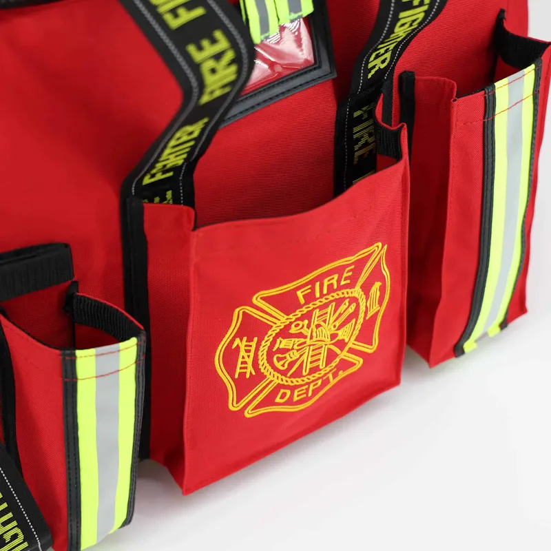 Close-up of the red Lightning X LXFB20 turnout gear bag's front pockets with embroidered Fire Dept. Maltese cross and reflective striped trim.