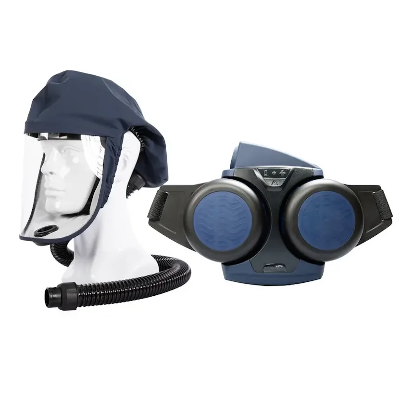 Sundström® SR 500/SR 520 M/L powered air purifying respirator system in navy blue, featuring a short fabric hood with a clear face shield and breathing hose on a mannequin head beside the belt-worn blower unit with dual round filters and adjustable waist straps.