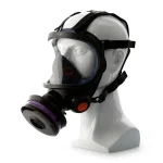 Sundström® SR 200 full face mask in black with a wide clear lens and inner nose cup, shown on a mannequin head with adjustable head straps, a purple-banded filter cartridge on the side, and an orange exhalation valve cover.