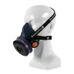 Sundström® SR 100 M/L half mask respirator with a navy blue silicone facepiece, shown on a mannequin head with black adjustable head straps, a purple-banded filter cartridge on the side, and an orange exhalation valve cover.