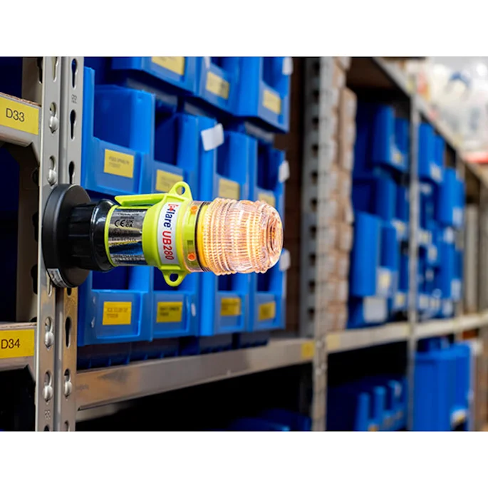 Eflare UB280 magnetic LED safety beacon attached to a warehouse shelving rack for visual hazard marking in storage aisles.