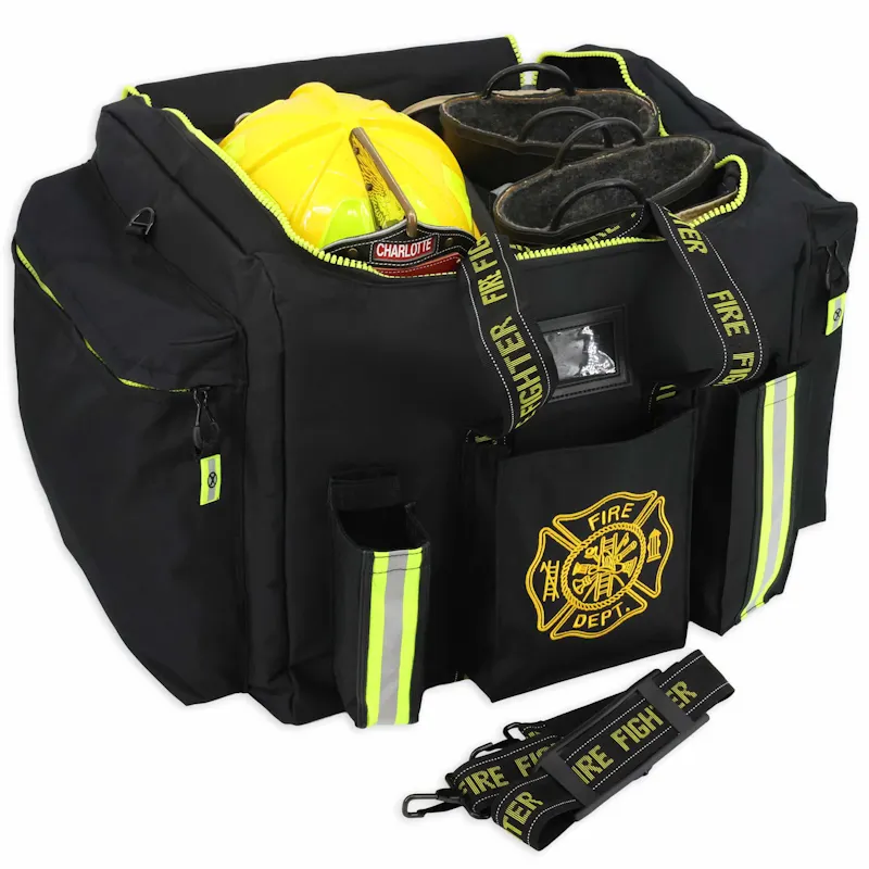 Open Lightning X LXFB20 black turnout gear bag holding a yellow fire helmet and boots, with a detached Fire Fighter shoulder strap.