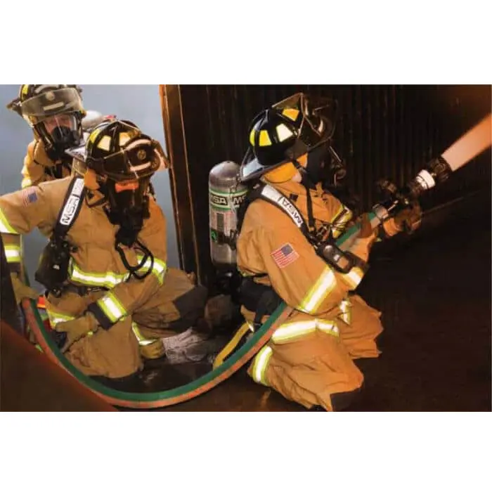 Three firefighters holding and operating the BullDog™ Hi-Combat® Firefighting Hose in use, demonstrating teamwork and the hose’s durability under intense firefighting conditions.