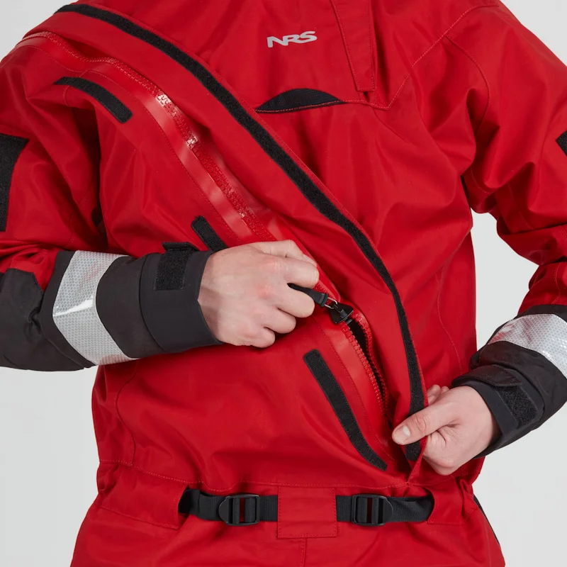 Closeup of a man wearing the NRS Extreme SAR Dry Suit in red, adjusting the heavy-duty waterproof front zipper at chest height.