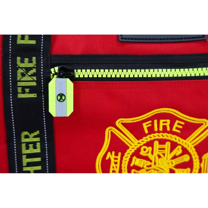 Closeup of front zipper near medical emblem on Lightning X LXFB10 red variant, displaying smooth, durable hardware.