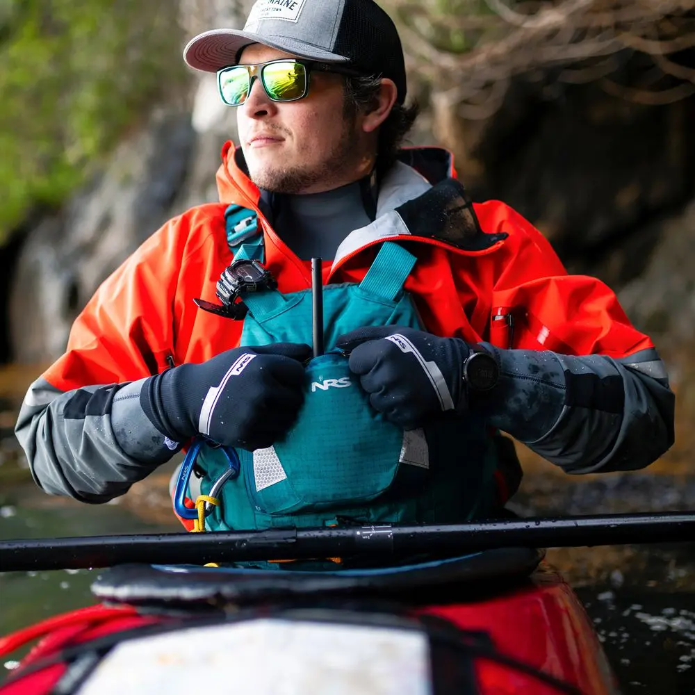 Man paddling a kayak while wearing NRS Men's HydroSkin Gloves for warmth, grip, and water protection.
