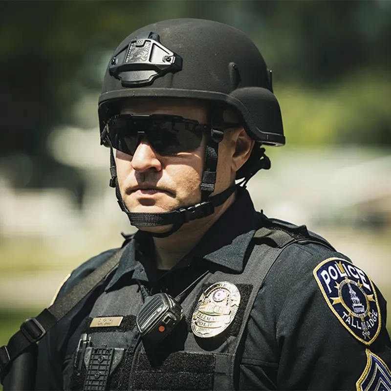 Close-up of a policeman wearing the Team Wendy® EPIC™ Responder Ballistic Helmet outside, emphasizing the helmet’s secure fit, padding, and durable finish.