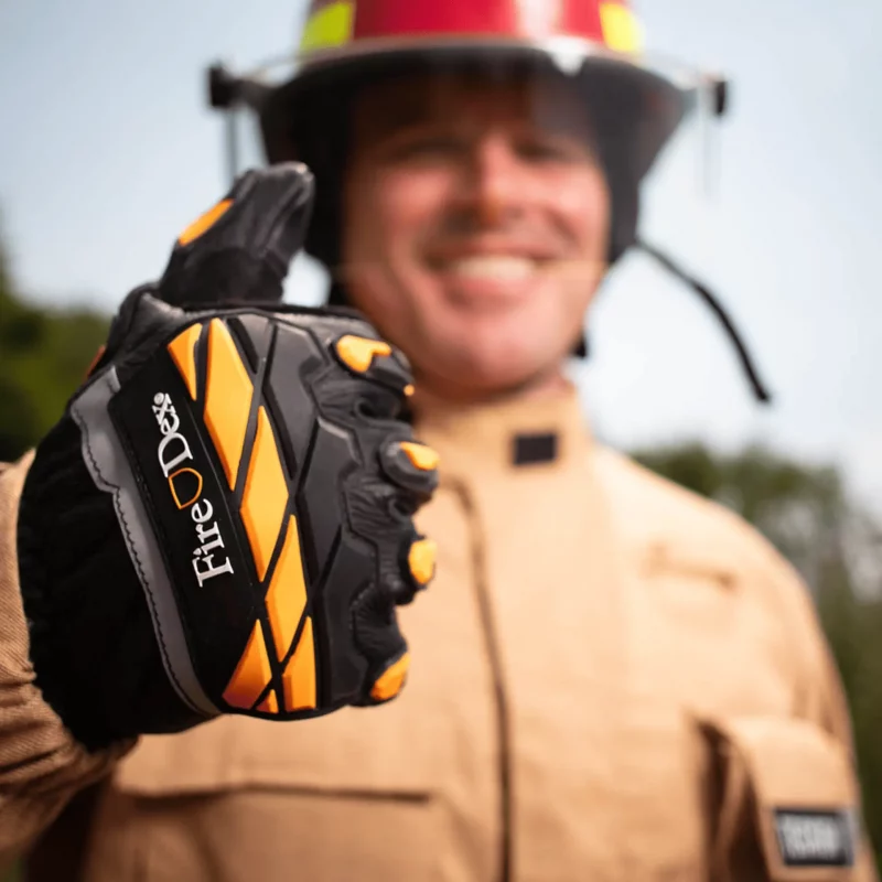 Firefighter wearing Fire-Dex® Dex-Rescue gloves giving a thumbs up, demonstrating glove fit and flexibility in rescue scenarios.
