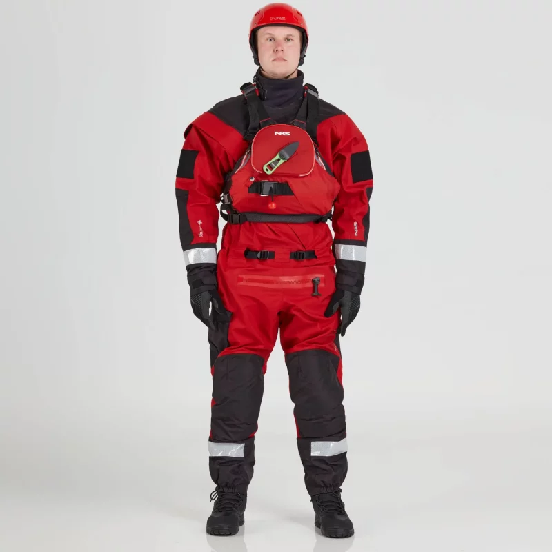 Front view of a man wearing the NRS Ascent SAR Dry Suit in red with a red equipment bag secured on the chest, highlighting the suit’s waterproof fabric and rescue gear setup.