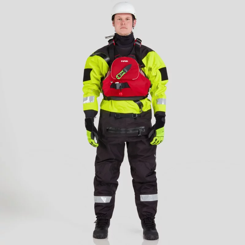 Front view of a man wearing the NRS Ascent SAR Dry Suit in safety yellow with a red equipment bag secured on the chest, highlighting the suit’s waterproof fabric and rescue gear readiness.