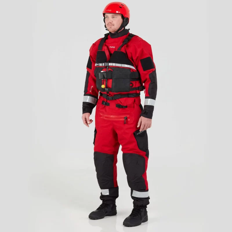 Front side view of a man wearing the NRS Extreme SAR Dry Suit in red with a red equipment bag on the chest, highlighting ergonomic fit and durable build.