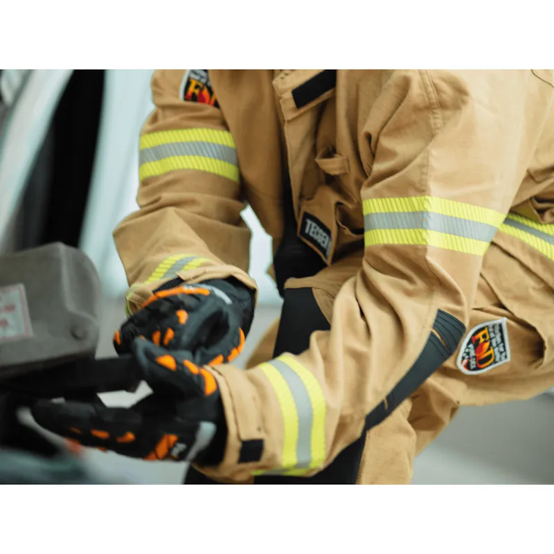 Firefighter in tan turnout gear wearing Fire-Dex® Dex-Rescue NFPA 1951 Technical Rescue Firefighter Gloves while gripping rescue equipment.
