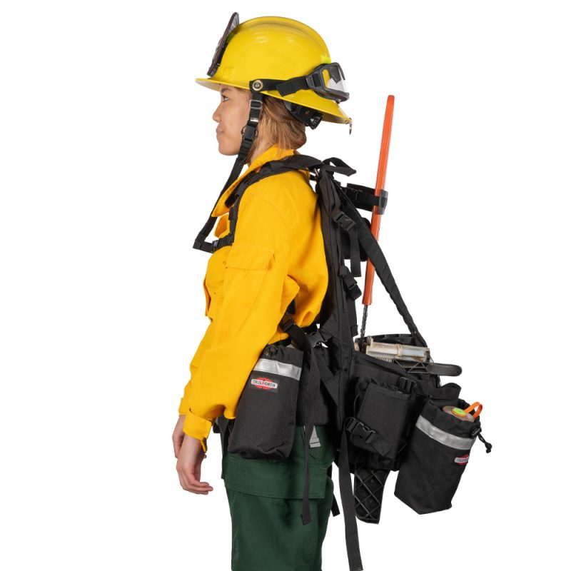 Side view of person wearing True North Gear Chainsaw Pack highlighting padded straps, storage compartments, and chainsaw securely fastened on the pack.