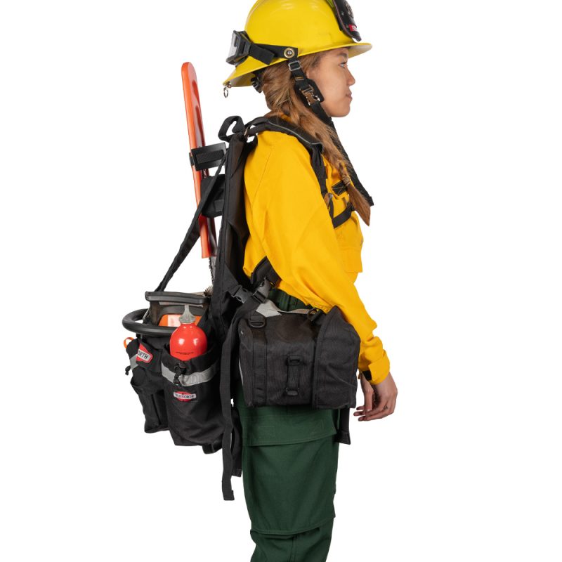 Alternate side view of person wearing True North Gear Chainsaw Pack showing adjustable straps, multiple storage pockets, and securely held chainsaw.