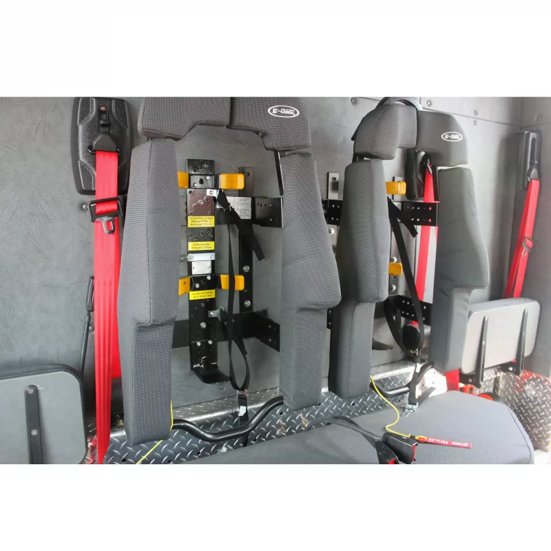Two empty Ziamatic™ Load & Lock SCBA Brackets mounted on firetruck seats, ready to securely hold self-contained breathing apparatus (SCBA) for quick access during emergencies.