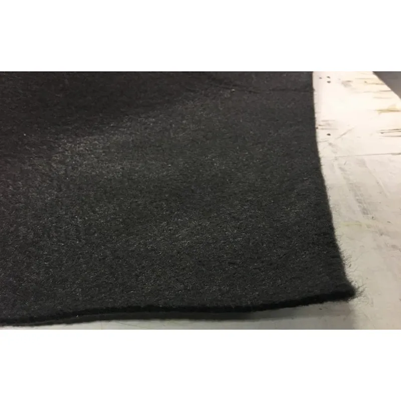 Close-up of a black felt-style Husky® ground tarp and cover material lying flat on a work surface.