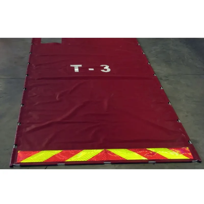 Close-up top view of Husky® Hose Bed Covers laid on the ground, showcasing the durable material and reinforced edges designed for long-lasting protection of firefighting hoses.