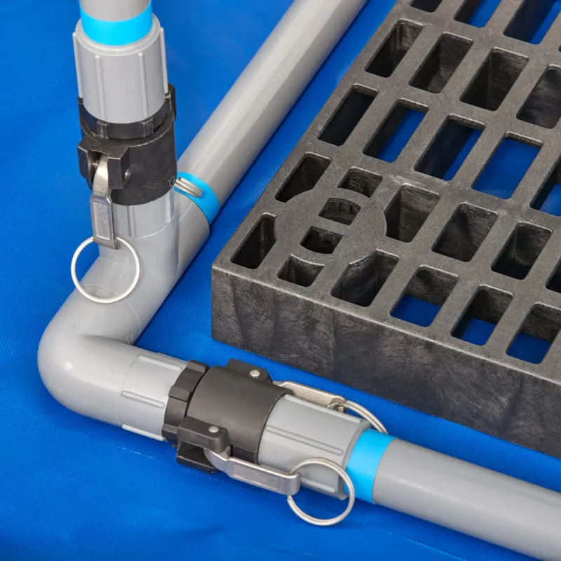 Close-up image of the pipe structure on the floor of the DQE® MasCas® II Decontamination Shower System, showing the assembled base frame used to support the portable mass decontamination unit.