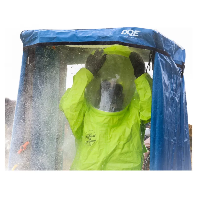Person inside the DQE® HMK1101A Standard Decontamination Shower System using the shower, demonstrating its functionality for effective emergency decontamination.