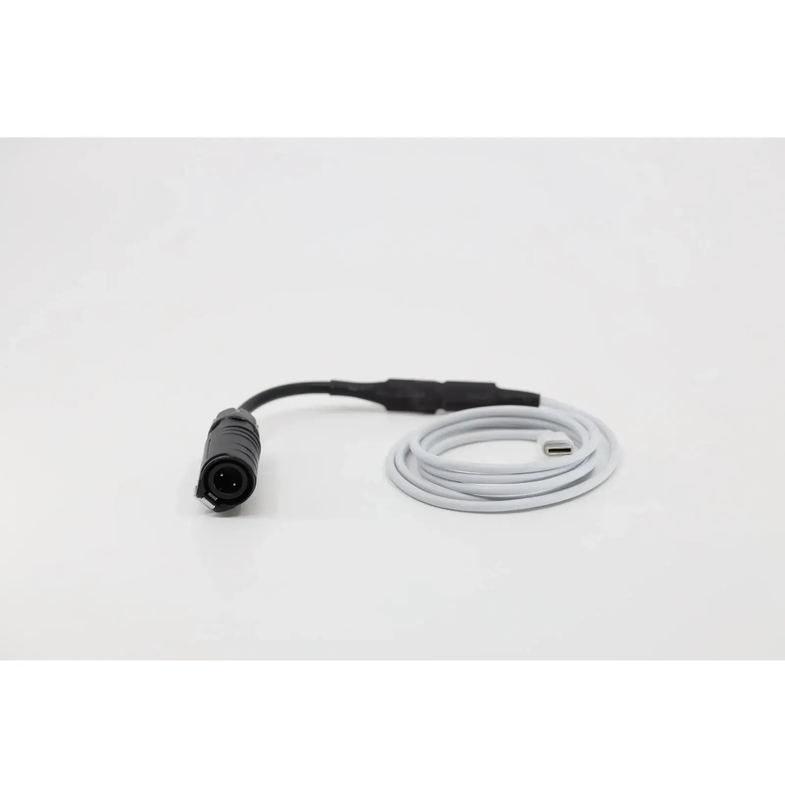 Angled view of a NightRide Trailblazer Portable Battery Cable with 2-pin connector showing cable flexibility and connector details.