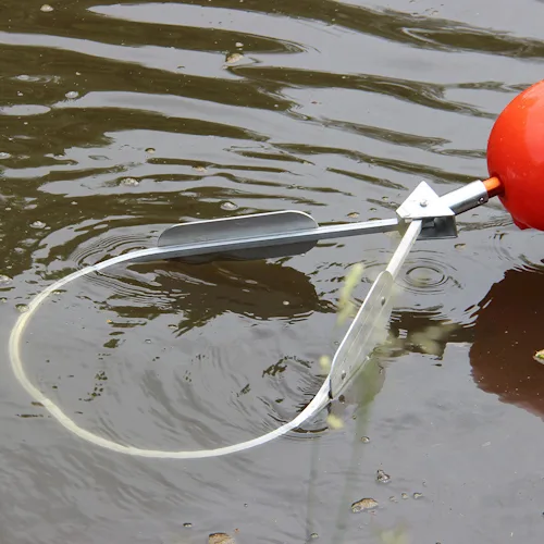 Northern Diver water rescue jaws attachment with buoy floating on rippling water, open loop mechanism visible for grasping.
